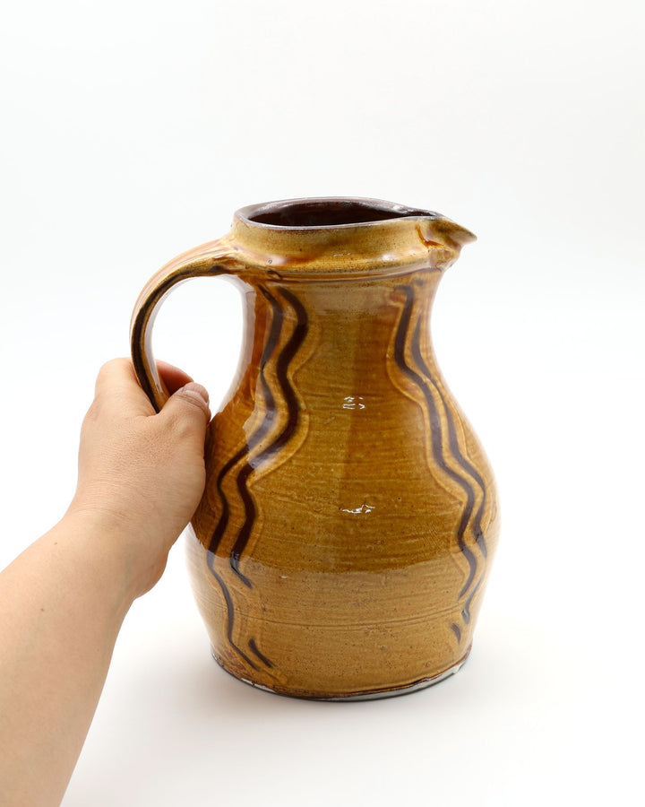 小鹿田焼 坂本浩二窯の7寸太ピッチャー。飴釉の深い色合いに、指描きによるダイナミックな景色の文様が施された低重心の器。