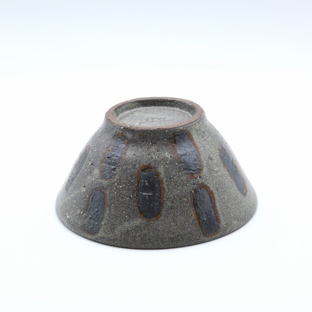 sora potters workによる、ザラりとした渋い鉄砂の器肌に点打ち紋が大胆に描かれた手作りのマカイ（お茶碗）。