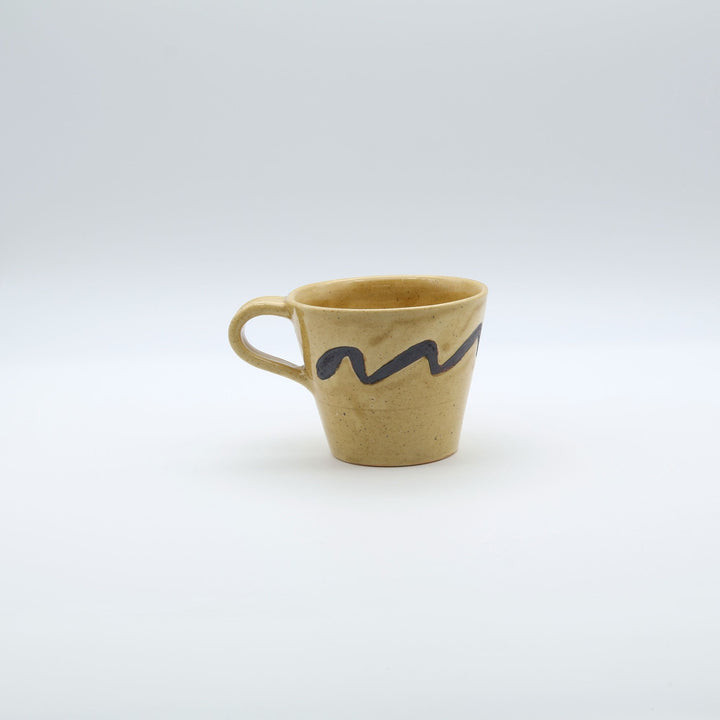 沖縄のsora potters workによる、はちみつ色に波模様が施されたやちむんの大きめマグカップ