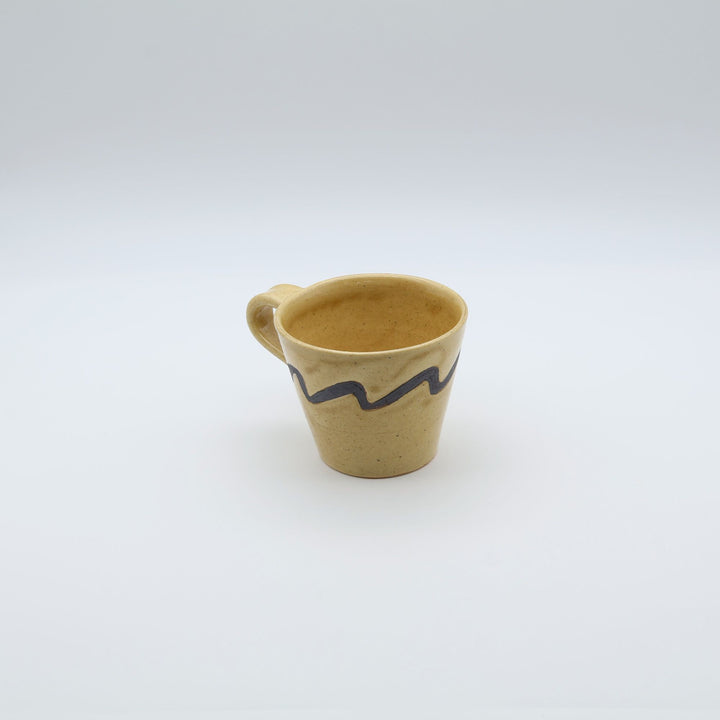 沖縄のsora potters workによる、はちみつ色に波模様が施されたやちむんの大きめマグカップ